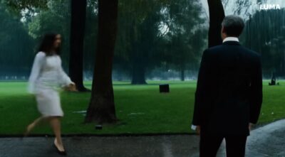 man with suit walks in the park on a rainy day, when he meets him self and say hallo-1eefce